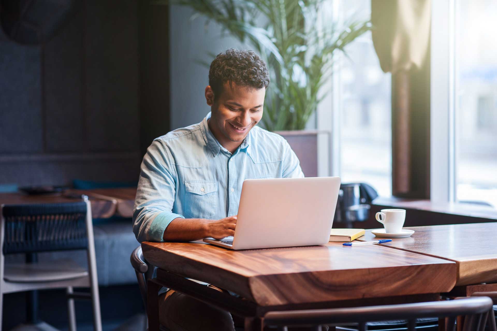 man on laptop smiling